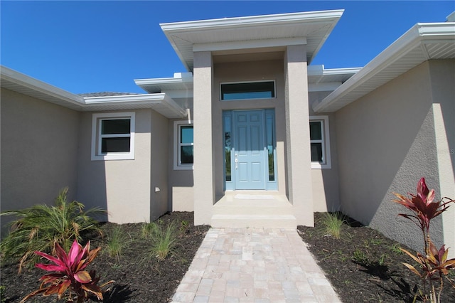 property entrance featuring stucco siding