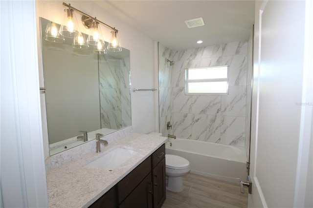 full bathroom featuring vanity, toilet, tub / shower combination, and visible vents