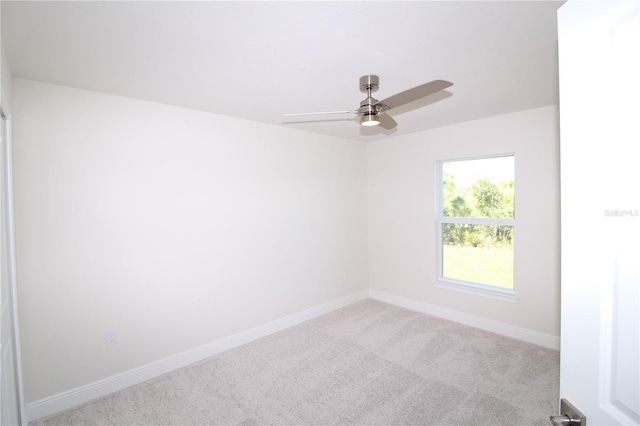 empty room with baseboards, carpet floors, and a ceiling fan