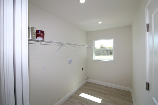 laundry room featuring hookup for a washing machine, baseboards, hookup for an electric dryer, laundry area, and light wood-type flooring