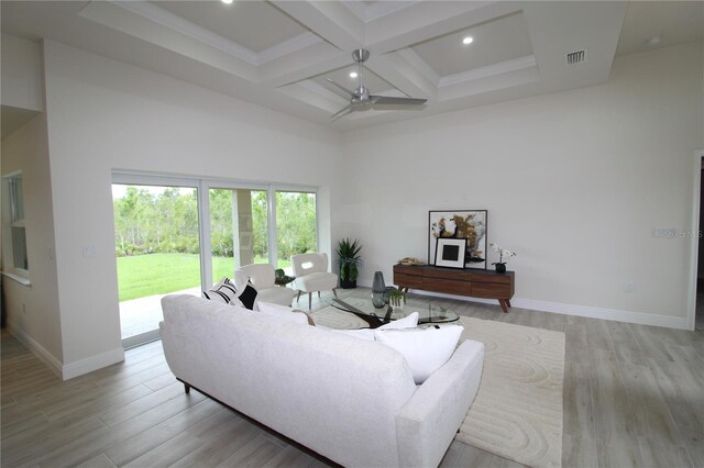 9529 Calumet Blvd, Port Charlotte, FL 33981 - living room with beam ceiling, light wood finished floors, coffered ceiling, a high ceiling, and baseboards