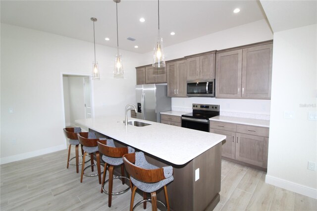 9529 Calumet Blvd, Port Charlotte, FL 33981 - kitchen with stainless steel appliances, a sink, a kitchen island with sink, light countertops, and baseboards