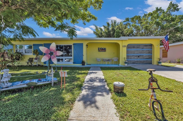 view of front of home with stucco siding, a garage, concrete driveway, and a front yard