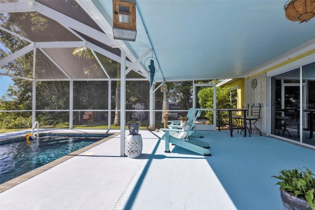 outdoor pool with glass enclosure and a patio