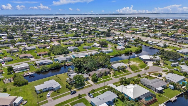 drone / aerial view featuring a residential view and a water view