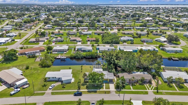 birds eye view of property featuring a residential view and a water view