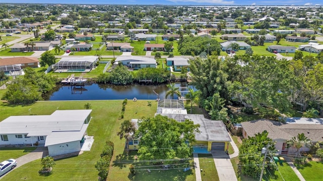 drone / aerial view featuring a residential view and a water view