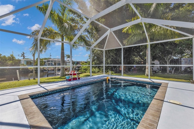 pool with a lanai and a patio area