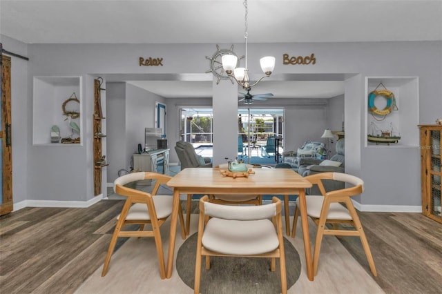 dining area with an inviting chandelier, baseboards, and wood finished floors