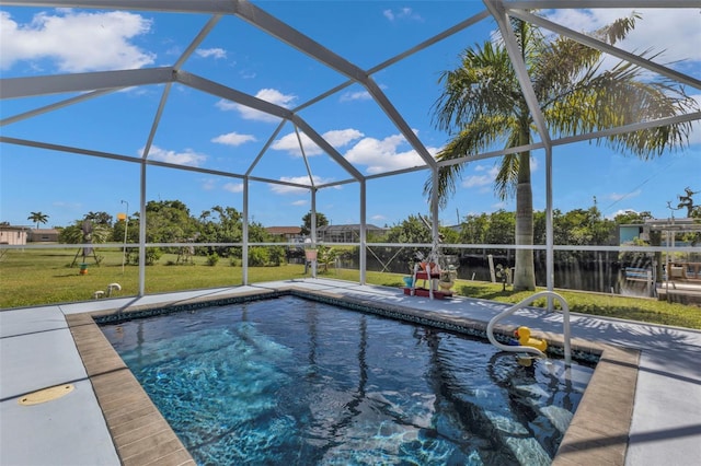 outdoor pool with glass enclosure, a patio, and a lawn