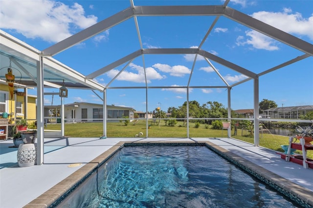 outdoor pool featuring a lanai, a lawn, and a patio