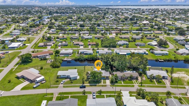 birds eye view of property with a residential view and a water view