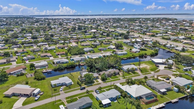 drone / aerial view featuring a residential view and a water view