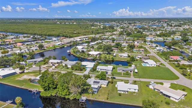 drone / aerial view with a residential view and a water view