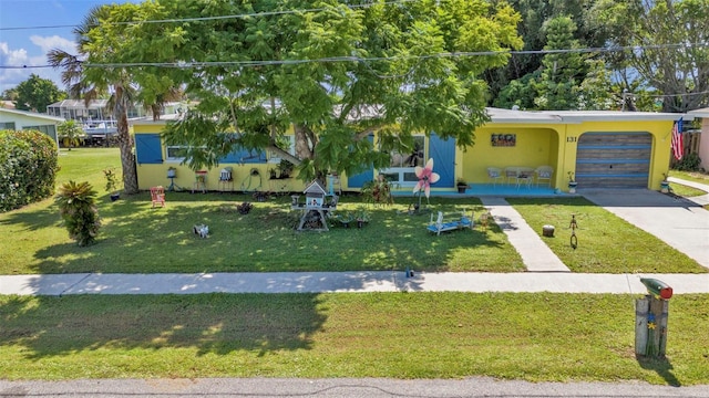 view of front of home featuring concrete driveway, stucco siding, a garage, and a front lawn