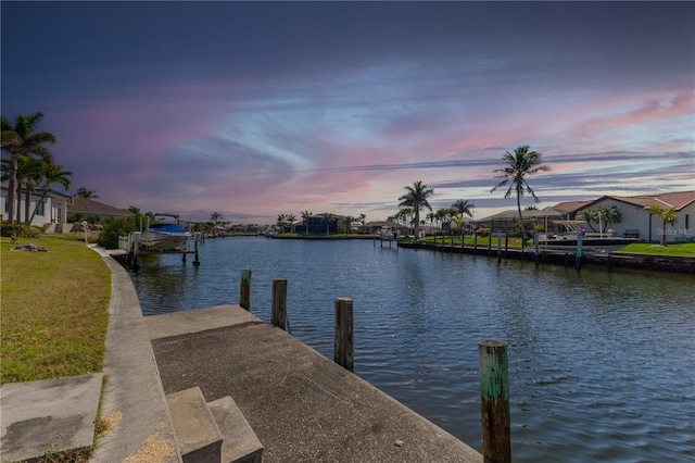 view of dock featuring a yard, a residential view, and a water view