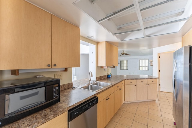 kitchen with light brown cabinets, a sink, appliances with stainless steel finishes, light tile patterned flooring, and a peninsula