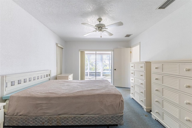 unfurnished bedroom featuring visible vents, a textured ceiling, carpet flooring, and access to outside