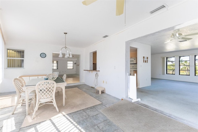 dining space featuring visible vents and a ceiling fan