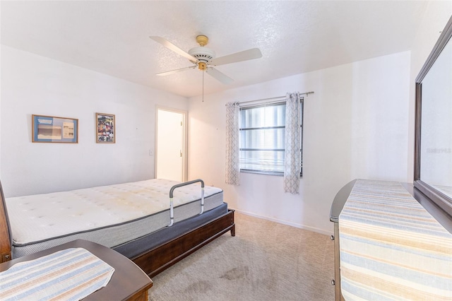 carpeted bedroom featuring a ceiling fan and baseboards