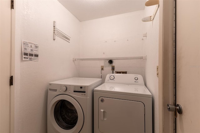 clothes washing area featuring laundry area and independent washer and dryer