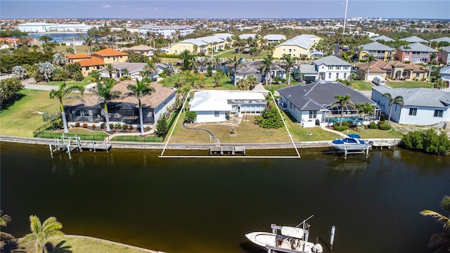 drone / aerial view with a residential view and a water view