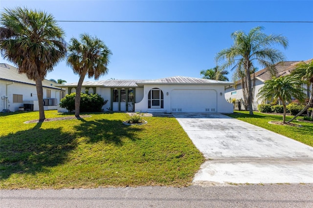 single story home featuring an attached garage, driveway, and a front yard