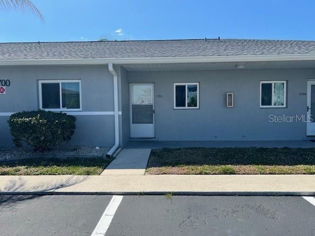 12274 SW Egret Cir Unit 3703, Lake Suzy, FL 34269 - entrance to property featuring stucco siding and roof with shingles