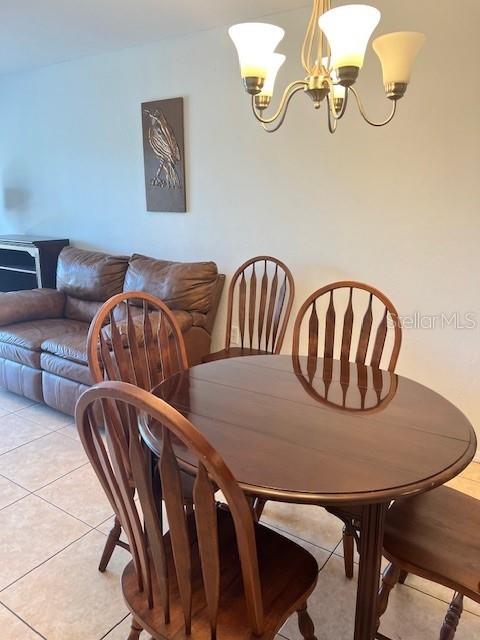 12274 SW Egret Cir Unit 3703, Lake Suzy, FL 34269 - dining area featuring a chandelier and light tile patterned flooring