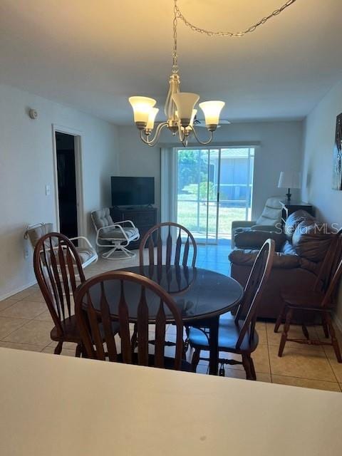 12274 SW Egret Cir Unit 3703, Lake Suzy, FL 34269 - dining area featuring light tile patterned floors and a chandelier