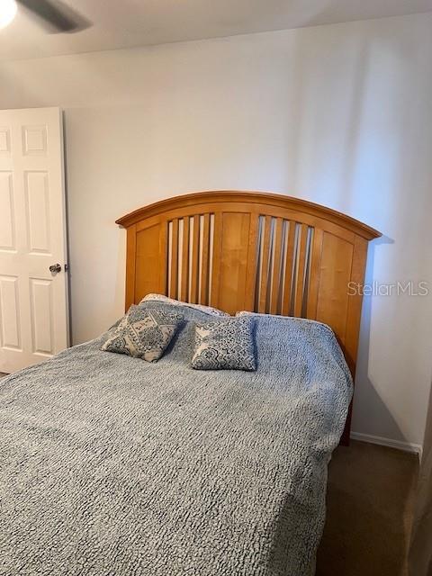 12274 SW Egret Cir Unit 3703, Lake Suzy, FL 34269 - bedroom featuring dark carpet and ceiling fan