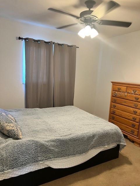 12274 SW Egret Cir Unit 3703, Lake Suzy, FL 34269 - carpeted bedroom featuring a ceiling fan