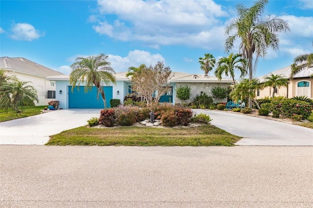 view of front of home with stucco siding, concrete driveway, and a garage