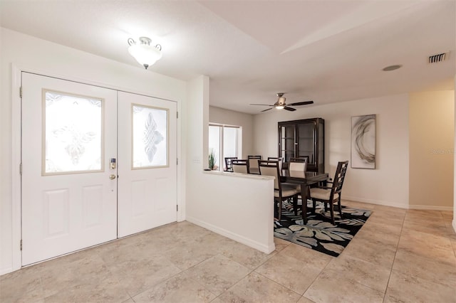 foyer entrance featuring baseboards, visible vents, french doors, and ceiling fan