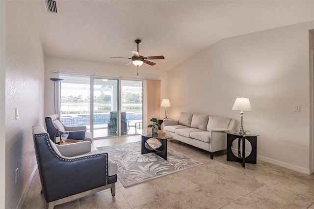 living area with visible vents, baseboards, ceiling fan, and vaulted ceiling