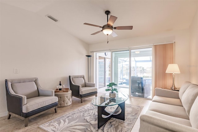 living area featuring visible vents, a ceiling fan, and vaulted ceiling