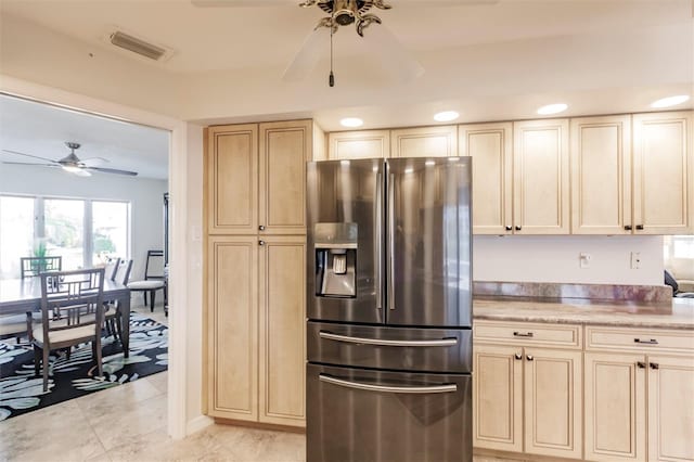 kitchen with visible vents, light brown cabinets, light countertops, stainless steel refrigerator with ice dispenser, and a ceiling fan