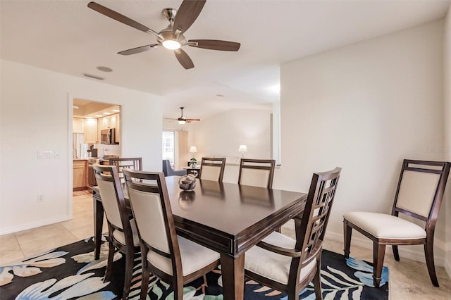 dining space with light tile patterned floors, visible vents, baseboards, and a ceiling fan