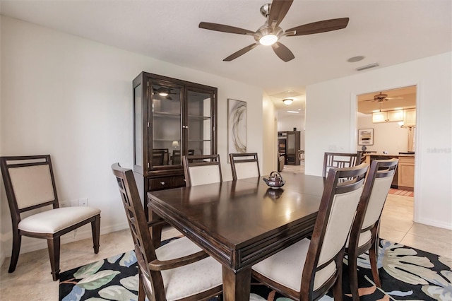 dining area featuring light tile patterned floors, a ceiling fan, visible vents, and baseboards