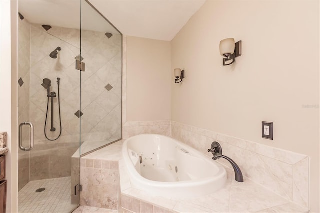 bathroom with a tub with jets, a stall shower, and vanity