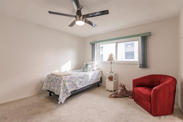 carpeted bedroom with baseboards and a ceiling fan