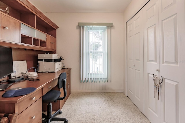 office space featuring baseboards and light speckled floor