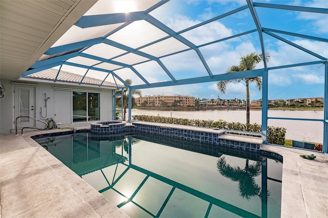 view of pool featuring a patio area, a pool with connected hot tub, a lanai, and a water view