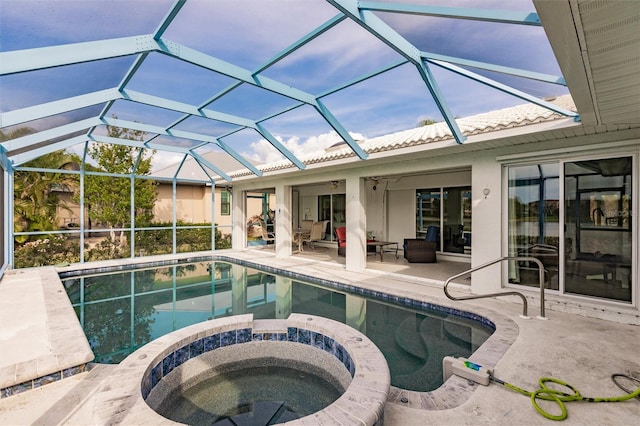 view of pool with a patio, a pool with connected hot tub, and a lanai