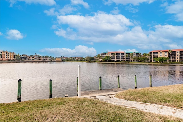 dock area featuring a lawn and a water view