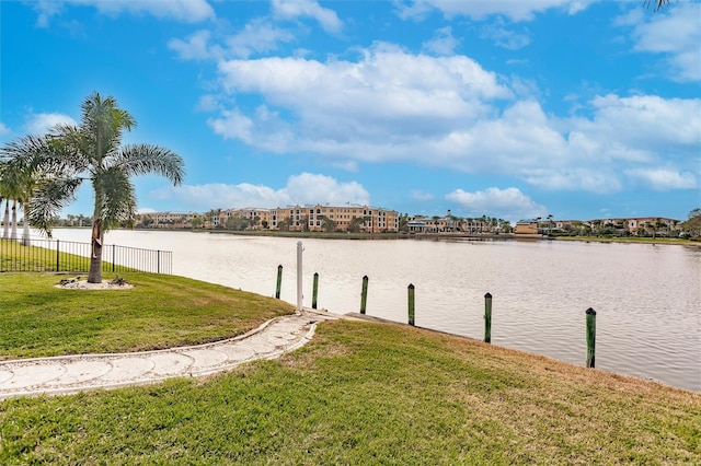 exterior space with a water view and fence