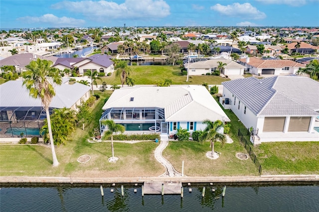 birds eye view of property with a residential view and a water view