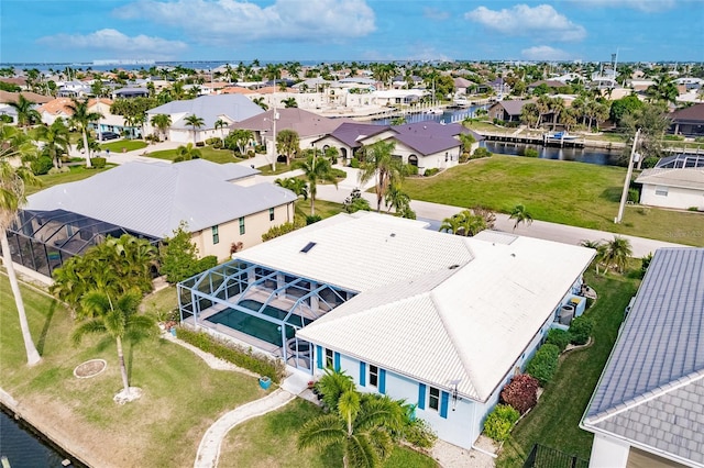 drone / aerial view with a residential view and a water view