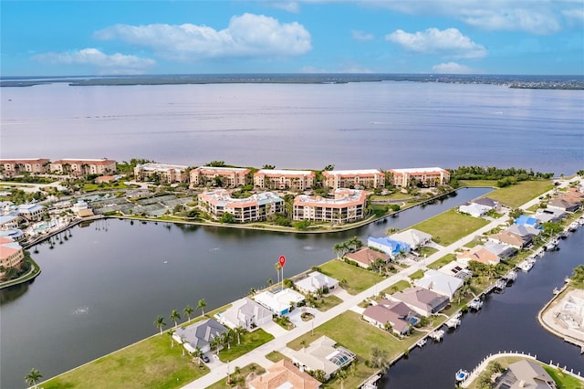 birds eye view of property with a water view and a residential view