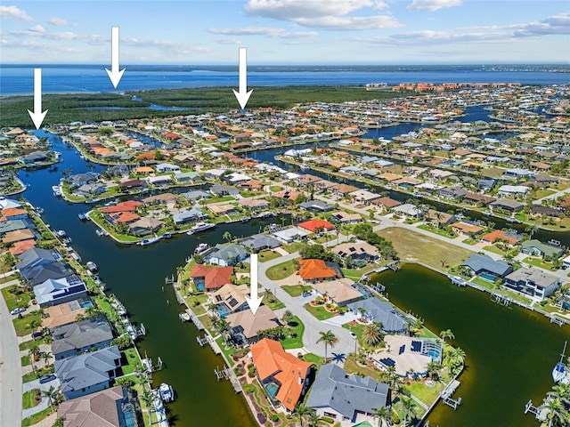 drone / aerial view featuring a water view and a residential view